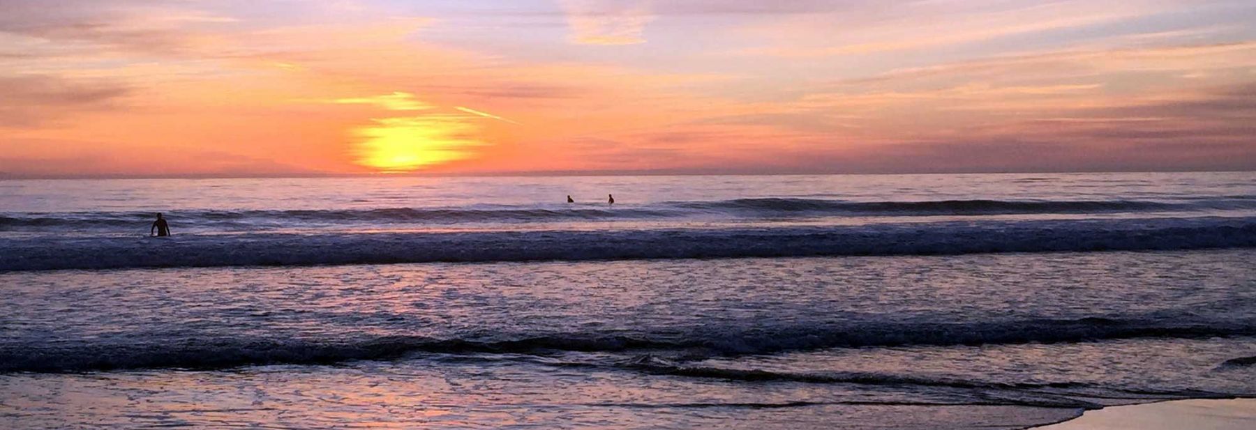 Beach sunset over surf